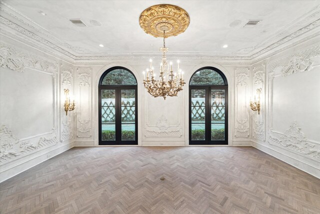 entryway with plenty of natural light, parquet flooring, and french doors