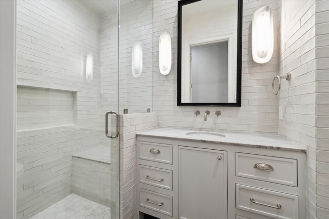 bathroom with vanity and a shower with shower door