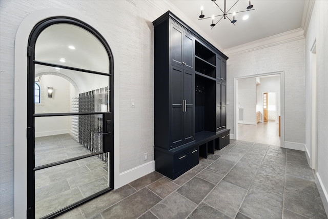 interior space with ornamental molding and a chandelier