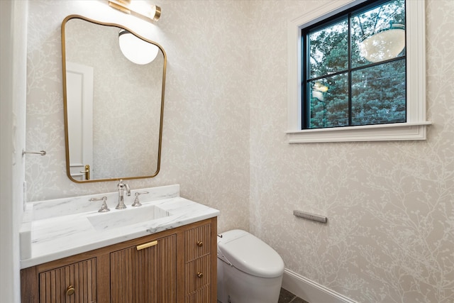 bathroom featuring vanity and toilet