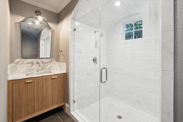 bathroom with ornamental molding, vanity, tile patterned flooring, and a shower with door