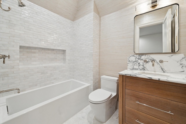 full bathroom with vanity, toilet, tiled shower / bath combo, and tile walls