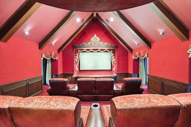 carpeted cinema room featuring vaulted ceiling with beams