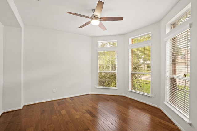 spare room with hardwood / wood-style flooring, a healthy amount of sunlight, and ceiling fan