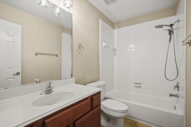 full bathroom with tiled shower / bath combo, vanity, and toilet