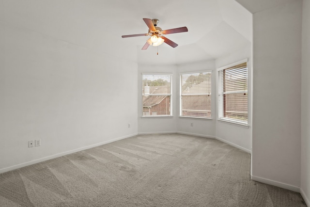 empty room with lofted ceiling, light colored carpet, and ceiling fan