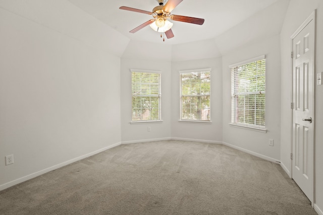 unfurnished room with lofted ceiling, ceiling fan, and light colored carpet