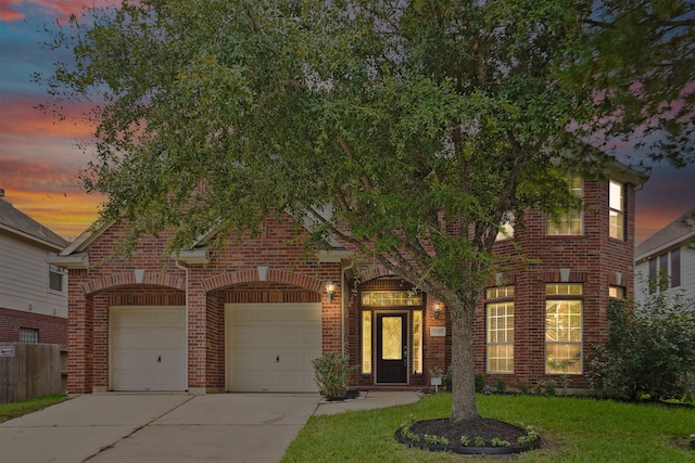 view of front of home featuring a garage and a lawn