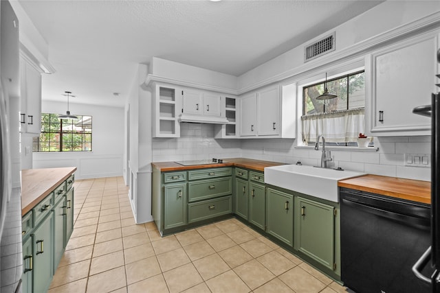 kitchen with green cabinetry, white cabinetry, sink, black appliances, and pendant lighting