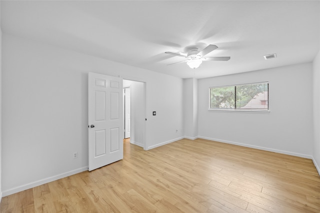 empty room featuring ceiling fan and light hardwood / wood-style floors