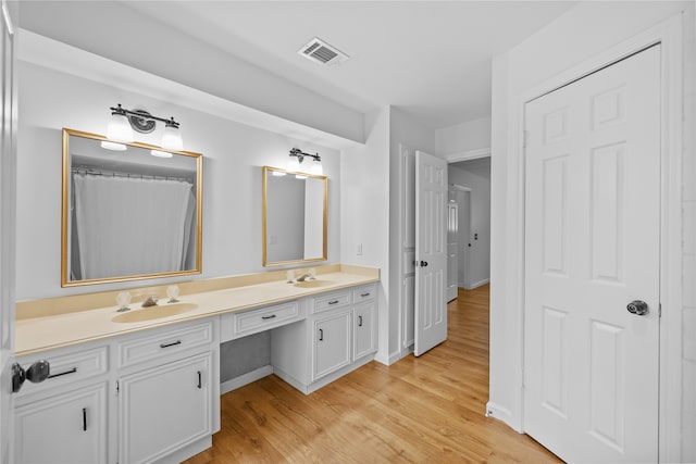 bathroom with hardwood / wood-style floors and vanity