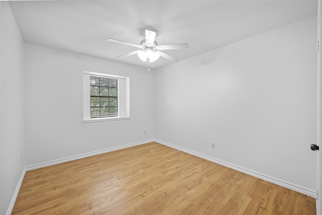 spare room with light wood-type flooring and ceiling fan