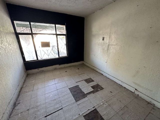 empty room featuring a textured ceiling