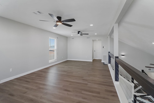 empty room featuring ceiling fan and dark wood-type flooring