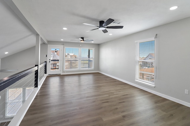 unfurnished living room with dark hardwood / wood-style floors and ceiling fan