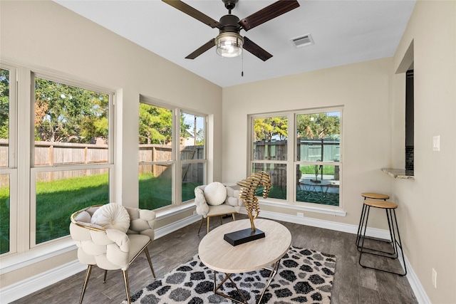 sunroom featuring ceiling fan