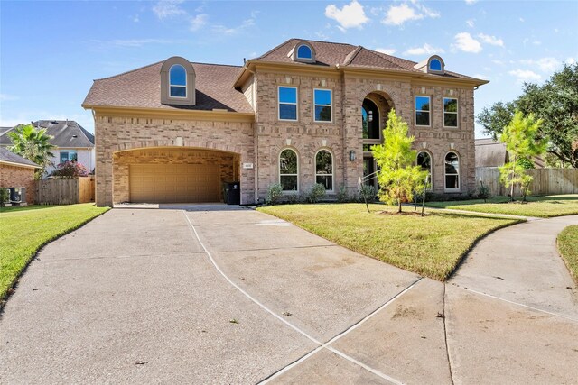 view of front of home featuring a garage and a front lawn