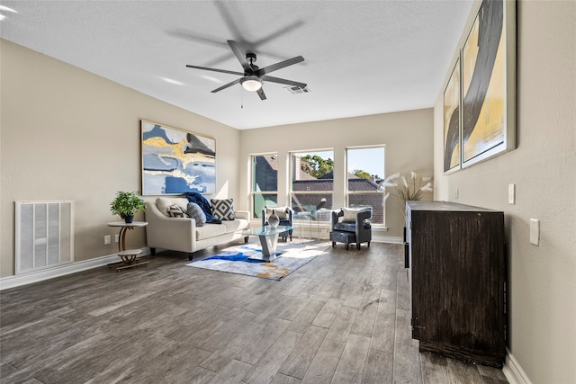 living room with hardwood / wood-style floors, ceiling fan, and a textured ceiling