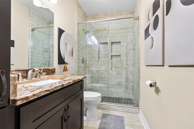 bathroom featuring vanity, an enclosed shower, and toilet