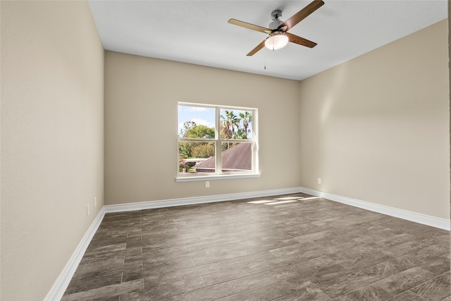 spare room with ceiling fan and dark hardwood / wood-style flooring