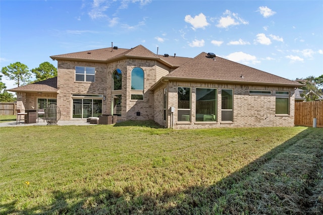 back of house with a lawn and a patio area