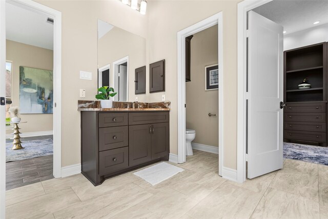 bathroom with vanity and toilet