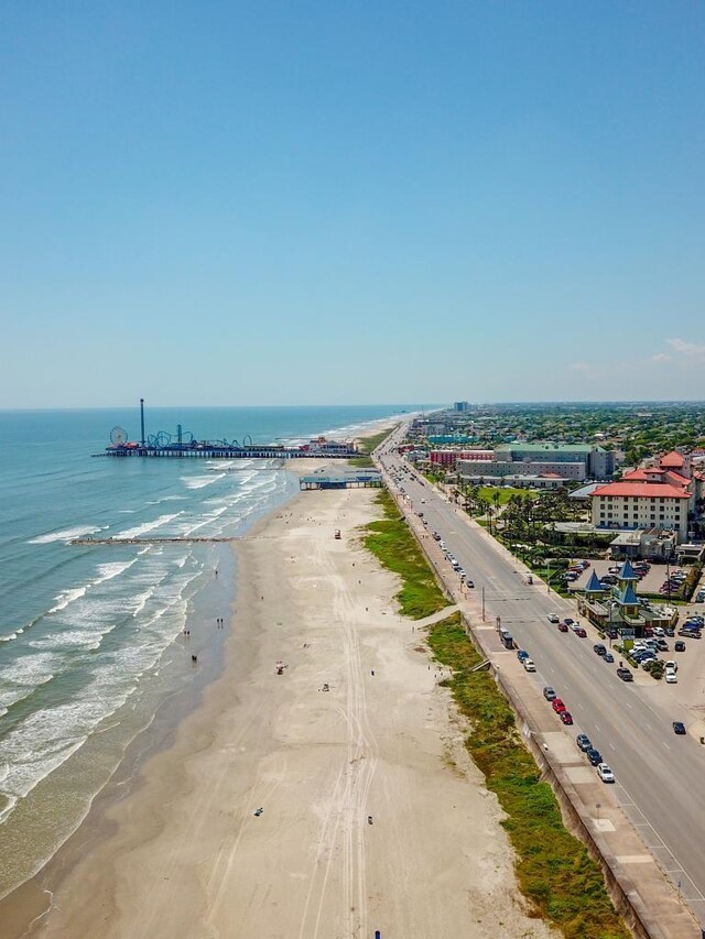 aerial view featuring a view of the beach and a water view