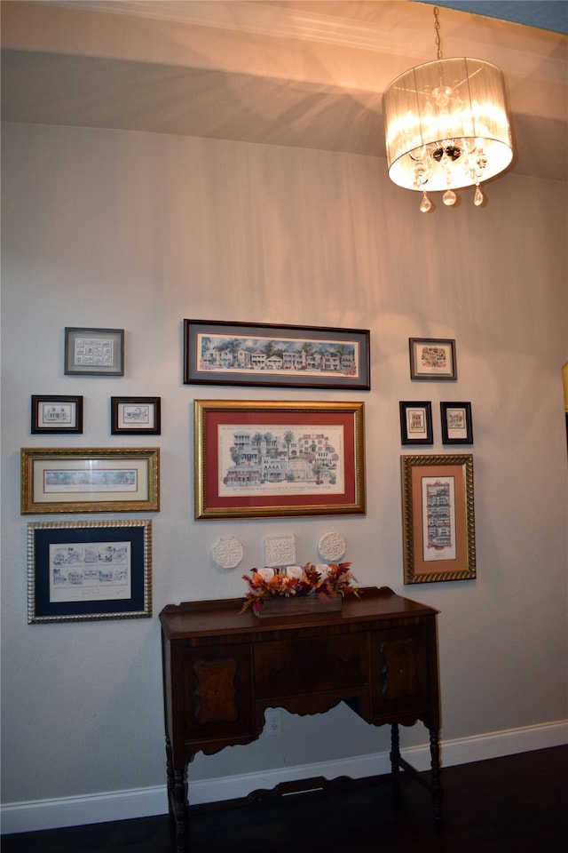 hall featuring a chandelier and dark wood-type flooring