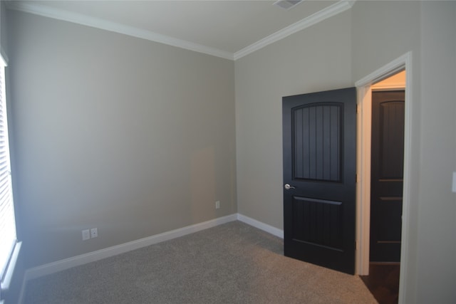 carpeted empty room with crown molding