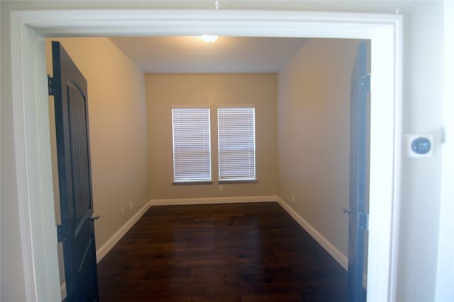 empty room with dark hardwood / wood-style floors