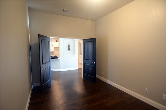 spare room featuring dark wood-type flooring