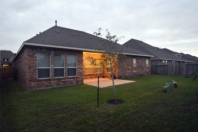 back of house featuring a patio and a lawn