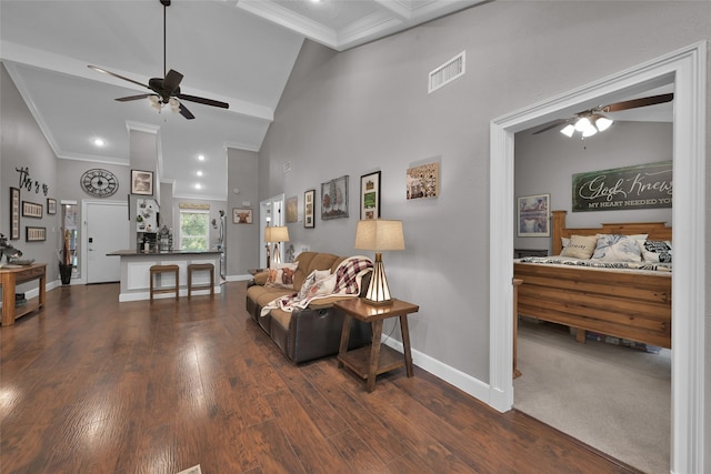 living room featuring dark wood-type flooring, ceiling fan, high vaulted ceiling, and crown molding