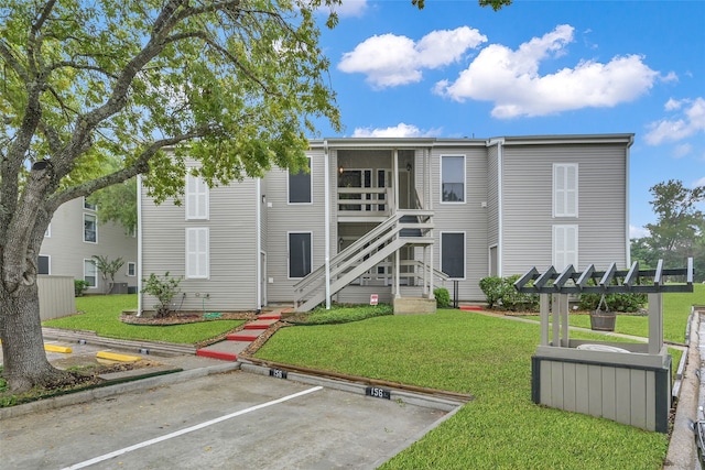 rear view of property with a lawn and a pergola