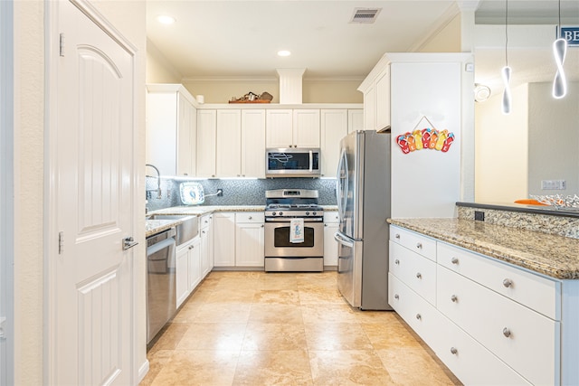 4010 Shallow Reef, Galveston, TX 77554 - kitchen with appliances with stainless steel finishes, a sink, ornamental molding, backsplash, and white cabinets