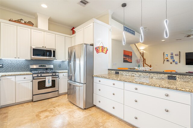 4010 Shallow Reef, Galveston, TX 77554 - kitchen featuring appliances with stainless steel finishes, crown molding, tasteful backsplash, a ceiling fan, and white cabinets
