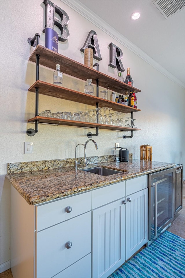 4010 Shallow Reef, Galveston, TX 77554 - indoor wet bar featuring crown molding, wine cooler, recessed lighting, a textured wall, and baseboards