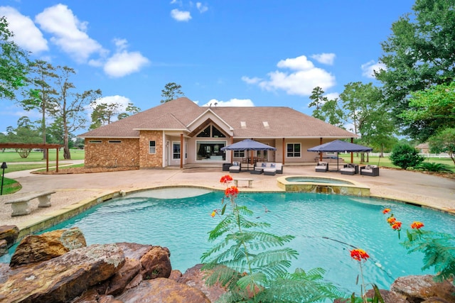 view of pool with a patio area, an in ground hot tub, and a gazebo