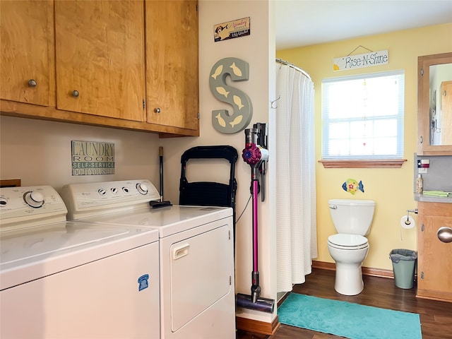 laundry area featuring dark hardwood / wood-style floors and washer and clothes dryer