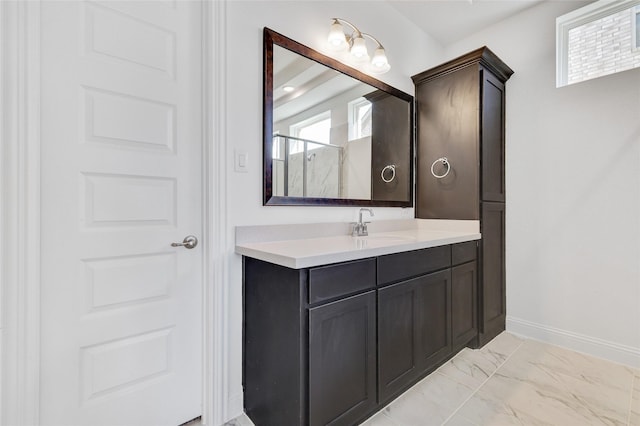 bathroom with an enclosed shower, marble finish floor, vanity, and baseboards