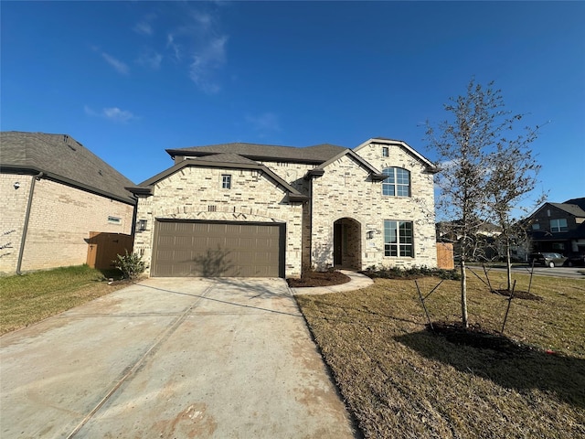 view of front facade with a garage and a front lawn