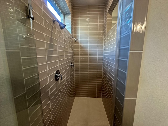 bathroom with a tile shower