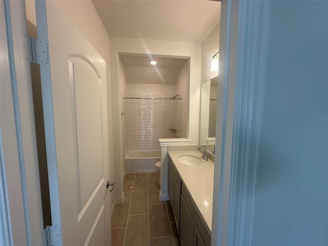 bathroom with tile patterned flooring, toilet, tub / shower combination, and vanity