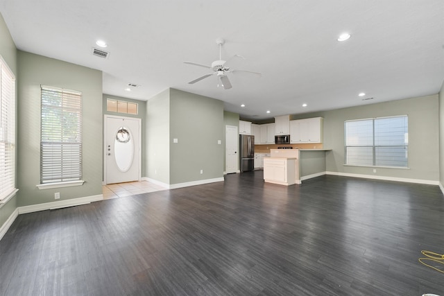 unfurnished living room with ceiling fan and dark hardwood / wood-style floors