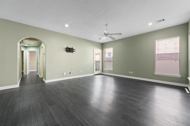 unfurnished room with a textured ceiling, ceiling fan, and dark hardwood / wood-style floors