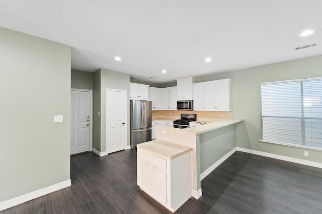 kitchen with stainless steel appliances, baseboards, dark wood-type flooring, and a peninsula