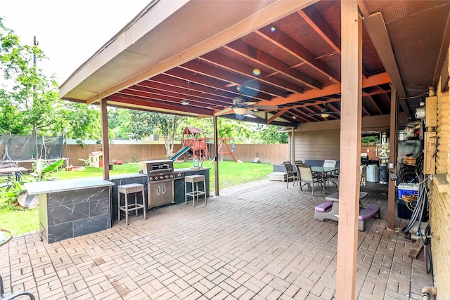 view of patio featuring a trampoline and a playground