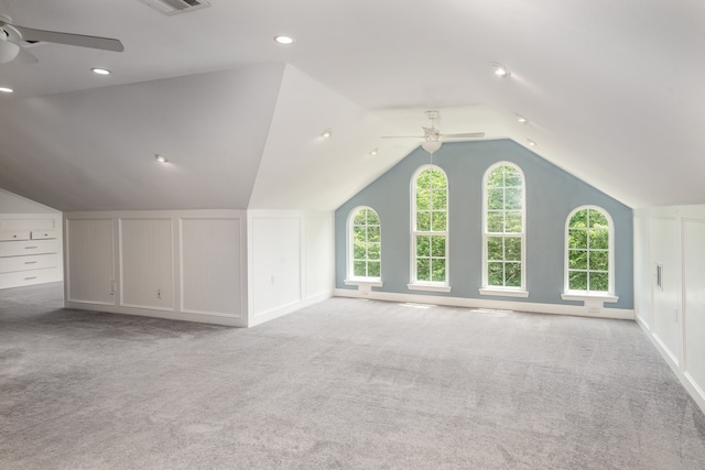 additional living space with light carpet, vaulted ceiling, and ceiling fan