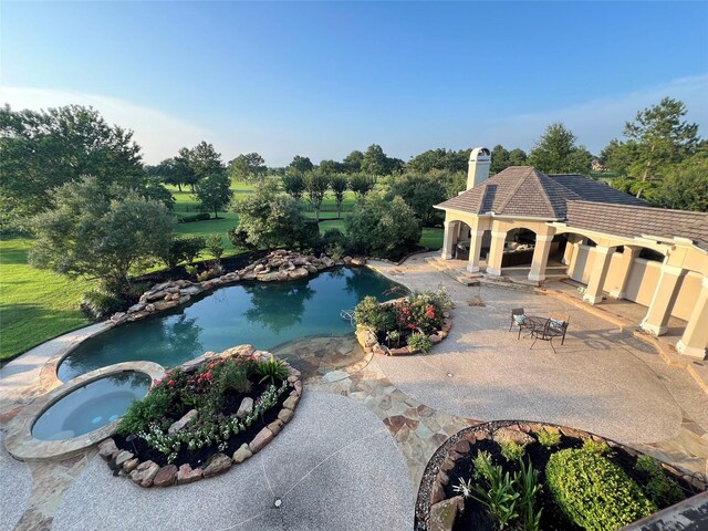 view of pool featuring a gazebo, a patio area, and an in ground hot tub