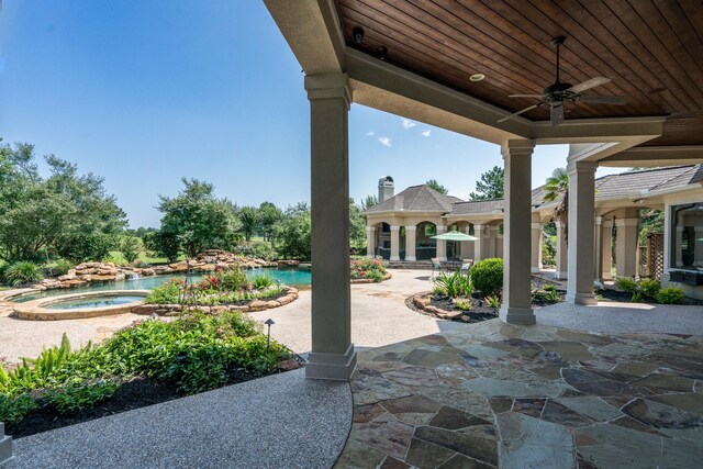 view of patio featuring a pool with hot tub and ceiling fan